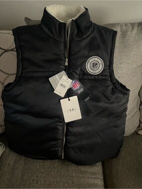 NFL Team Apparel Women's Black Puffer Vest with Sherpa Lining